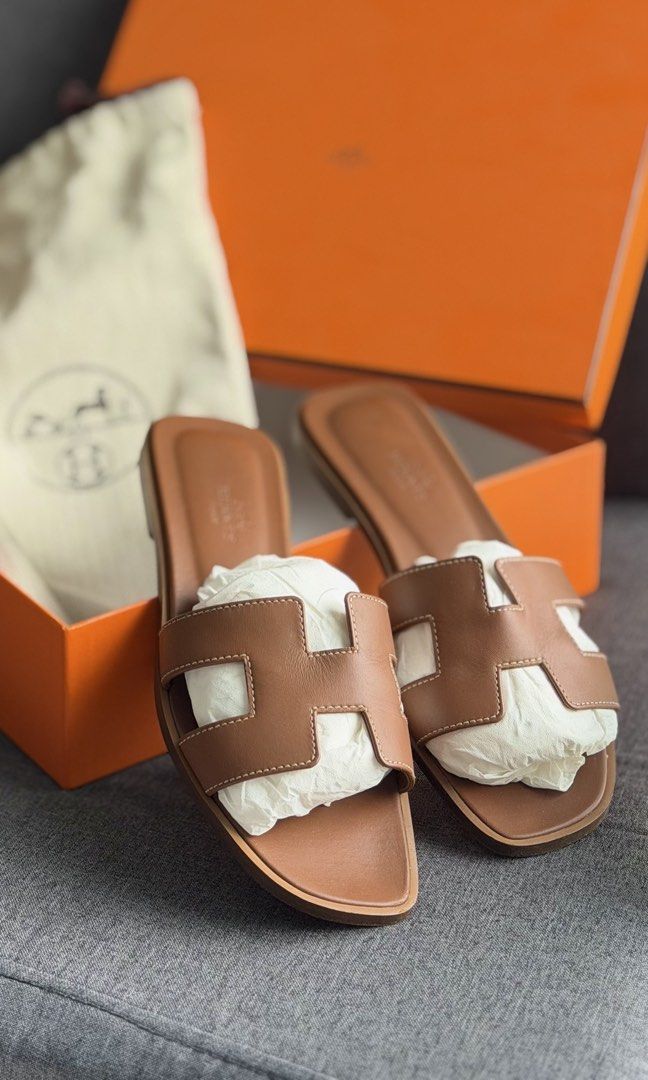 Authentic Hermès Oran Sandals with original box & dustbag (Category: Flats & Sandals) located in Quezon City. Submitted by mrzdc888 (Listing ID 1461398256, Image 1). Description: - Authentic Hermès Oran Sandals - Color: Gold - Size: EUR 36 (23.13cm or 9.1 inches) - Includes original box, original dust bag (2 pcs), original ribbon, and paper balls - Originally bought at Php55,000 - RFS: Size too small - Condition: 9.7/10 like new / Rarely used (ma