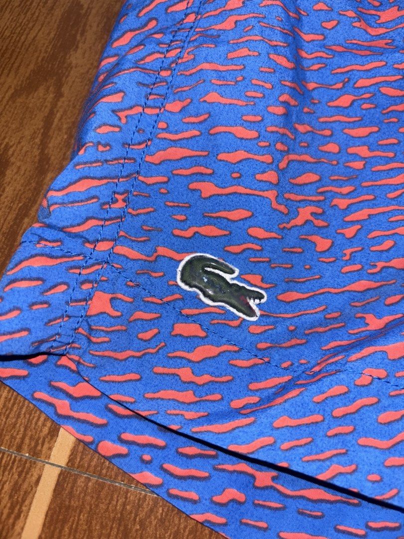 Authentic Lacoste Men’s Swim Shorts (Blue/Orange Pattern) 🐊🌊 (Category: Shorts) located in Tarlac. Submitted by jekzxkie (Listing ID 1461489944, Image 2). Description: Authentic Lacoste Swim Shorts / Trunks. Super fresh and unique blue/orange abstract pattern, perfect for your beach trips, pool sessions, or casual summer look! Condition: Excellent condition / No issues / No flaws Size on Tag: Medium Waistline: 32 to 36 inches (Garterized / Stre