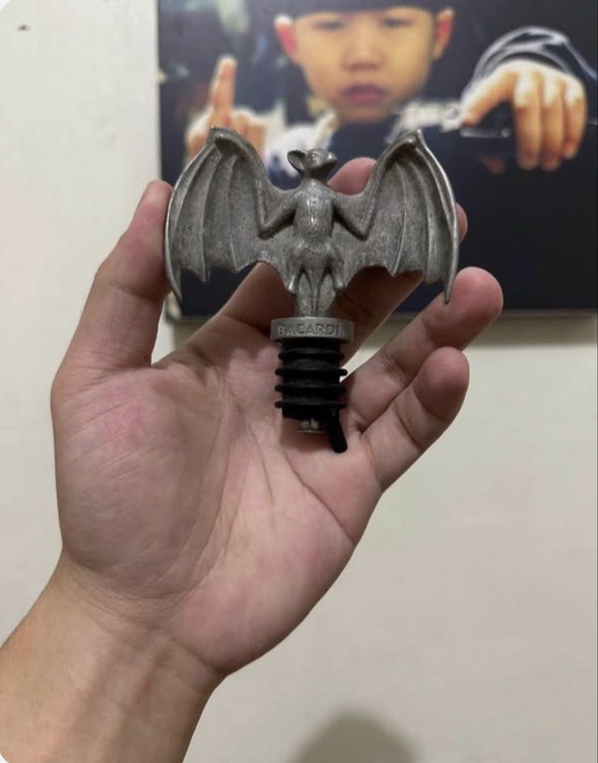 Bacardi Bat Wing Bottle Stopper Bar Tool (Category: Vintage Collectibles) located in Makati City. Submitted by lilmissgirl (Listing ID 1461539734, Image 1). Description: Bacardi Bat Liquor Rum Bottle Pourer Cork Stopper Shot Dispenser Halloween Party - Unique Bacardi bat wing design - Made of durable metal with a rubber seal - Fits most standard bottle sizes - Ideal for home bars and Bacardi collectors - A must-have accessory for fans.