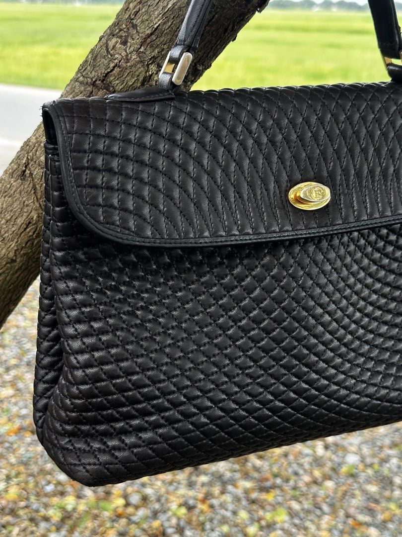 Bally Black Woven Leather Top Handle Handbag (Category: Luxury Bags & Wallets) located in Urdaneta. Submitted by redeemedcollective (Listing ID 1461525083, Image 3). Description: Vintage Bally handbag made in Italy, featuring an intricate woven/quilted black leather exterior, structured silhouette, dual top handles, and gold-tone logo turn-lock hardware. Beautiful vintage piece with a timeless, understated luxury look. Condition: Used / Fair** Th