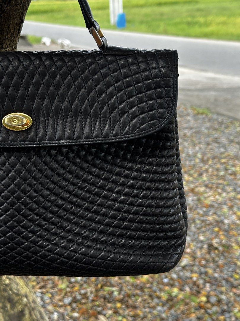 Bally Black Woven Leather Top Handle Handbag (Category: Luxury Bags & Wallets) located in Urdaneta. Submitted by redeemedcollective (Listing ID 1461525083, Image 2). Description: Vintage Bally handbag made in Italy, featuring an intricate woven/quilted black leather exterior, structured silhouette, dual top handles, and gold-tone logo turn-lock hardware. Beautiful vintage piece with a timeless, understated luxury look. Condition: Used / Fair** Th