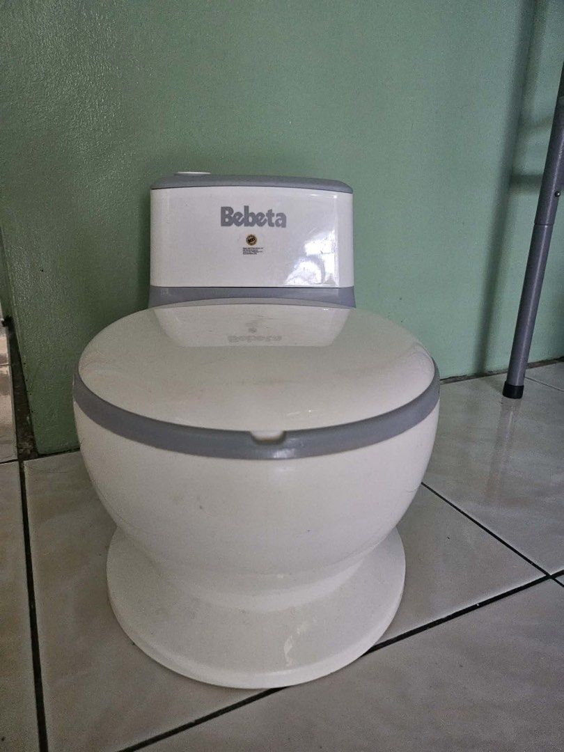 Bebeta Potty Training Toilet Seat (Category: Toilet Training) located in Quezon City. Submitted by fatcatgang (Listing ID 1461360724, Image 1). Description: Bebeta potty training toilet (white/grey). Features a lifting lid and removable inner potty for easy cleaning. Sturdy design to help your child learn to use the toilet. Not really used, na stock na lang and nalakihan.