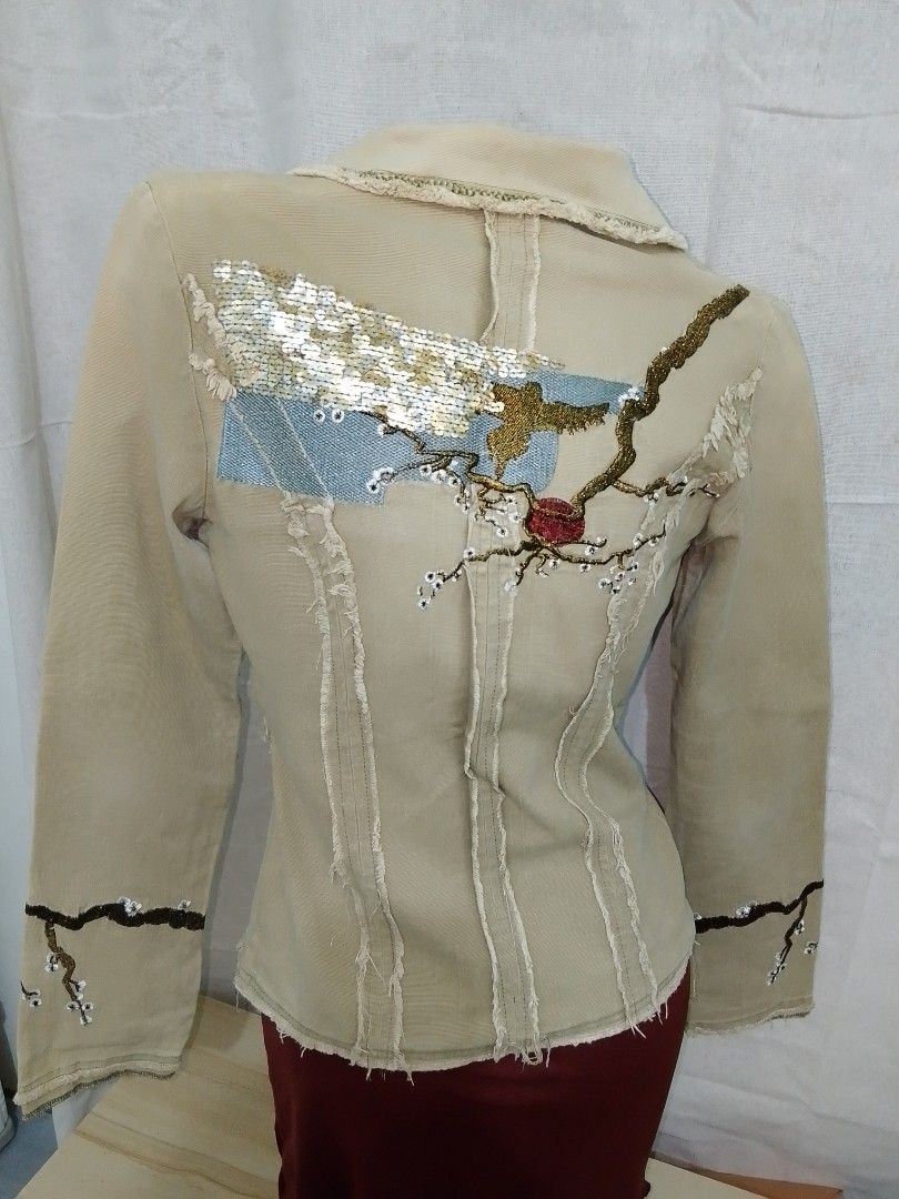 Beige Embroidered Jacket with Sequins (Category: Coats, Jackets and Outerwear) located in Manila. Submitted by crazyjhoyz (Listing ID 1461486169, Image 2). Description: - Beige jacket with unique embroidery on sleeves and back. - Features a stunning sequined floral design on the back panel. - Stylish raw hem details on collar, cuffs, and bottom hem. - Single button closure for a clean finish. - A truly unique and eye-catching piece..