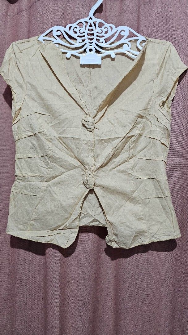 Beige Linen Blend Tie Front Cropped Top (Category: Blouses) located in San Jose del Monte. Submitted by stellarbeauty (Listing ID 1461421984, Image 1). Description: - Lightweight beige top - Unique tie-front closure - Subtle pleating on bodice and sleeves - Natural linen blend texture - Short sleeves - Cropped silhouette - Versatile for layering or wearing alone.