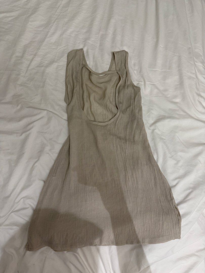 Beige Sleeveless beach cover up (Category: Dresses) located in Taguig. Submitted by jeyms_ (Listing ID 1461523799, Image 2). Description: - Lightweight beige mini dress - Sleeveless with scoop neckline - Open back with strap detail - Textured fabric - Ideal for casual wear or layering.