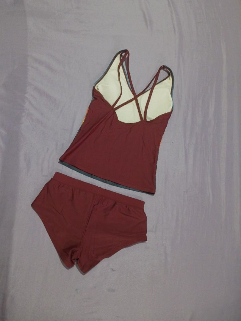 BENCH Beach Sunset Print Tankini & Shorts (Category: Bikinis & Swimsuits) located in Taguig. Submitted by maffieyat (Listing ID 1461488002, Image 2). Description: - Maroon two-piece swimsuit - Tankini top with vibrant beach sunset design - Features a stylish strappy back - Comes with matching maroon shorts - Ideal for swimming and beach activities - Can be used by girls ages 10 and up.