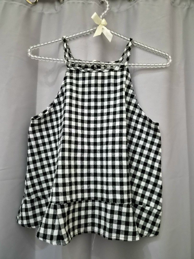 Black and White Gingham Ruffle Hem Halter Top (Category: Sleeveless) located in Manila. Submitted by manoygoodies (Listing ID 1461400160, Image 1). Description: - Adorable black and white gingham halter top - Features a cute ruffled hem detail - Strappy design for a stylish look - Likely fits size Small to Medium - Ideal for summer outfits or casual wear - Easily pairs with shorts or jeans.