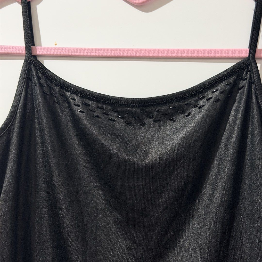 Black Camisole Top with Beaded Neckline (Category: Sleeveless) located in Guinobatan. Submitted by ktonkatsu (Listing ID 1461528630, Image 2). Description: - Sleek black camisole top - Features thin straps - Adorned with small beaded details at the neckline - Fabric has a subtle sheen - Versatile for layering or standalone wear.