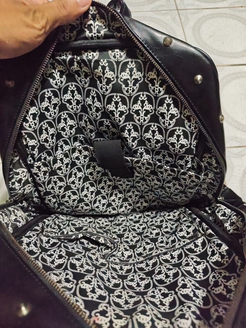 Black Faux Leather Skull Backpack with Buckles (Category: Backpacks) located in Isulan. Submitted by jaysthrift (Listing ID 1461456690, Image 3). Description: Cool black backpack with a skull design on the front. Lots of buckle details. The inside lining has a skull pattern too. Straps are adjustable. Some rust on the metal parts of the straps. Check photos for details. issue: sign of usage scratch and rust.