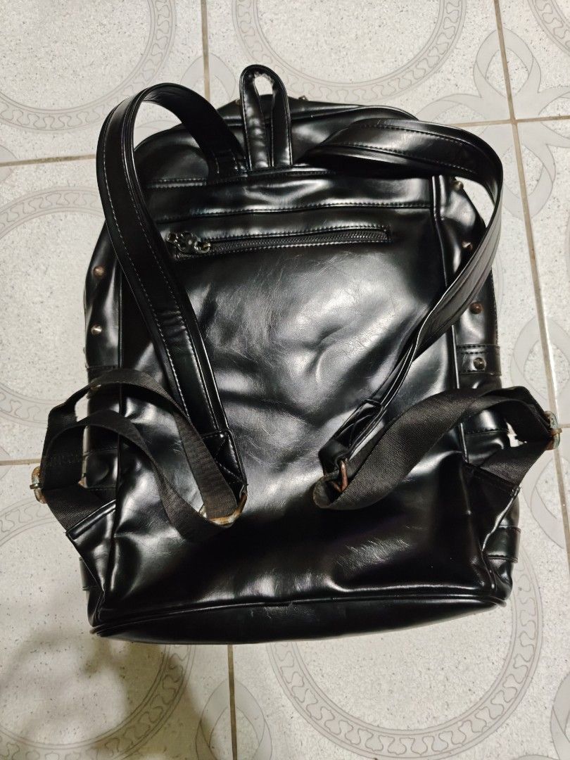 Black Faux Leather Skull Backpack with Buckles (Category: Backpacks) located in Isulan. Submitted by jaysthrift (Listing ID 1461456690, Image 2). Description: Cool black backpack with a skull design on the front. Lots of buckle details. The inside lining has a skull pattern too. Straps are adjustable. Some rust on the metal parts of the straps. Check photos for details. issue: sign of usage scratch and rust.