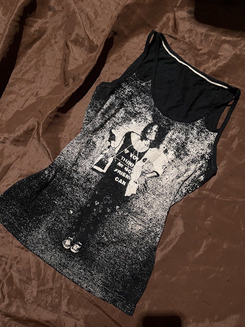 Black Graphic Tank Top with White Print (Category: Sleeveless) located in Dagupan City. Submitted by shanadongsb (Listing ID 1461506982, Image 1). Description: - Black tank top - Distressed white graphic print with quote and imagery - Spaghetti straps - Estimated size: Small to Medium - Ideal for casual wear.
