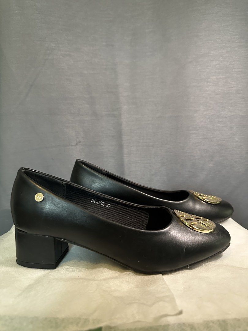 Black Heels (Category: Heels) located in Manila. Submitted by zarahzaraantig (Listing ID 1461458509, Image 2). Description: - Brand: Matthews - Type: Black Block Heels - Size: 37 - Features: Gold emblem on the front - Comfort: Comfortable for everyday wear - Versatile: Perfect for work or casual outings - Condition: Please check photos for details.