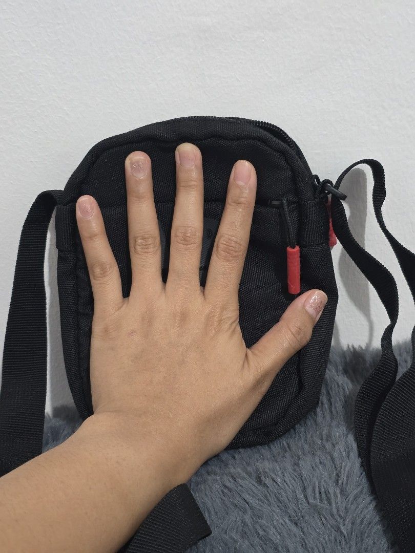 Black Jordan Crossbody Bag (Category: Sling Bags) located in Manila. Submitted by trialfindsmanila (Listing ID 1461502141, Image 3). Description: This is authentic 💯 from US Very good condition 💯 - Authentic Black Jordan Crossbody Bag - Features iconic Air Jordan logo on the front - Small red tag with Jumpman logo detail - Secure zipper closure - Adjustable strap for comfortable wear - Ideal for carrying your daily essentials Delivery or Pickup
