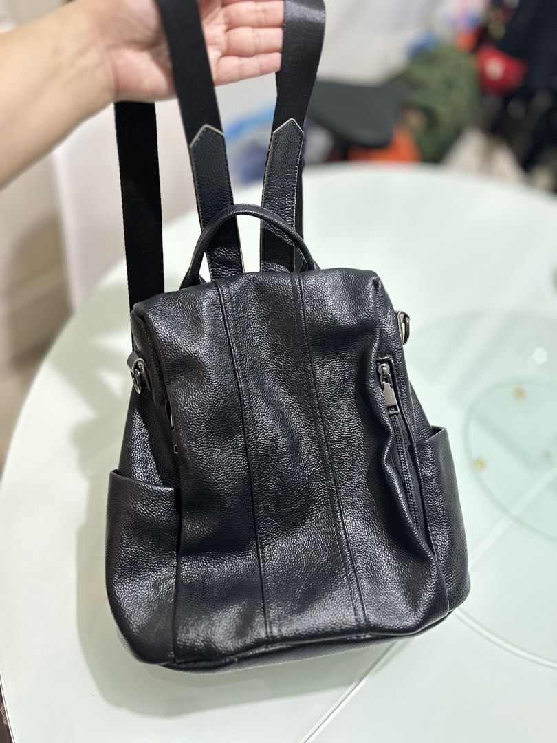 Black Leather Backpack (Category: Backpacks) located in Mandaluyong City. Submitted by TheWeekendProject (Listing ID 1461493342, Image 1). Description: - Genuine black leather backpack - Textured finish for a premium look - Convenient front zipper pocket - Handy side pockets for quick access - Spacious main compartment with zip closure at the back (has issue, not fully zipped) - Adjustable shoulder straps for a customized fit - Ideal for everyday