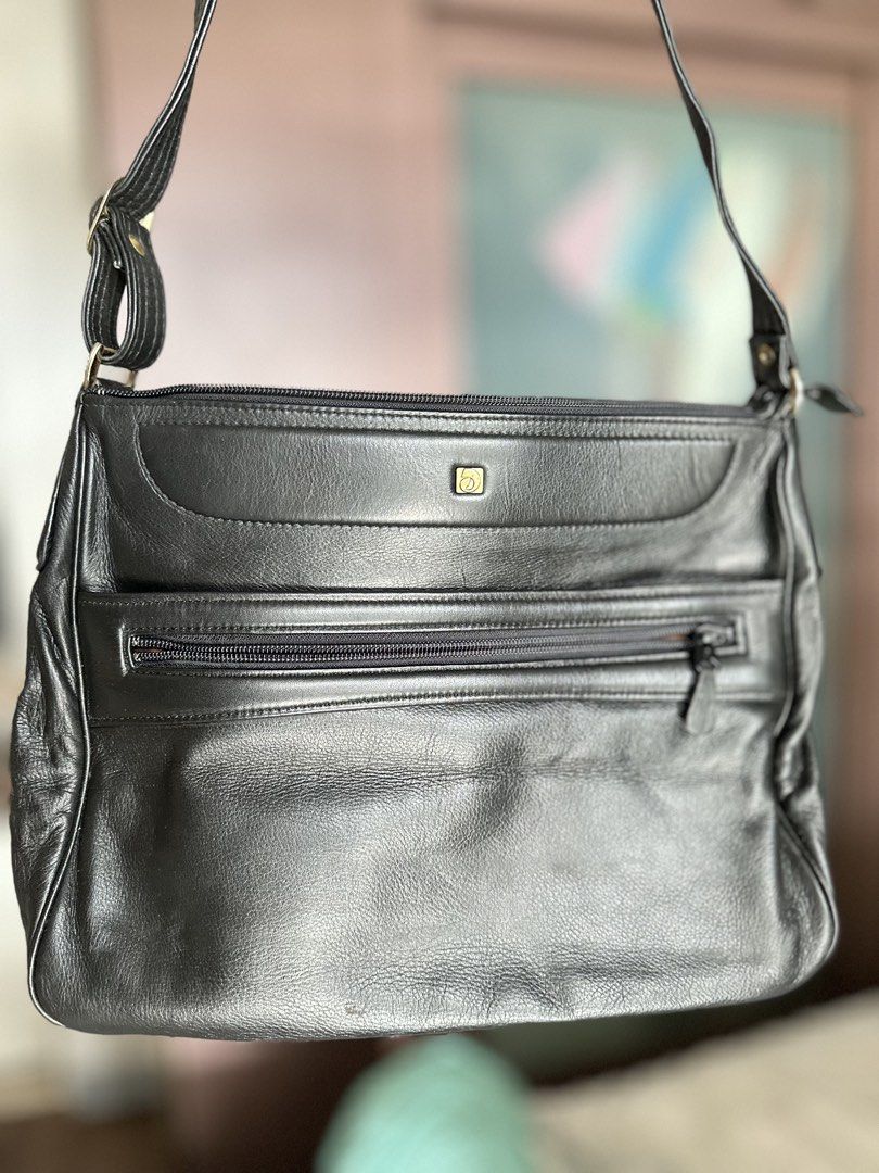 Black Leather Shoulder Bag with Multiple Zippers (Category: Cross-body Bags) located in Mandaluyong City. Submitted by TheWeekendProject (Listing ID 1461381660, Image 2). Description: - Stylish black genuine leather shoulder bag - Main zipper compartment for secure storage - Two front zipper pockets for easy access - Adjustable strap for comfortable wear - Elegant gold-tone hardware - Spacious enough for all your daily essentials - Ideal for ever