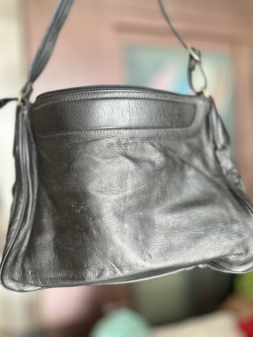 Black Leather Shoulder Bag with Multiple Zippers (Category: Cross-body Bags) located in Mandaluyong City. Submitted by TheWeekendProject (Listing ID 1461381660, Image 3). Description: - Stylish black genuine leather shoulder bag - Main zipper compartment for secure storage - Two front zipper pockets for easy access - Adjustable strap for comfortable wear - Elegant gold-tone hardware - Spacious enough for all your daily essentials - Ideal for ever