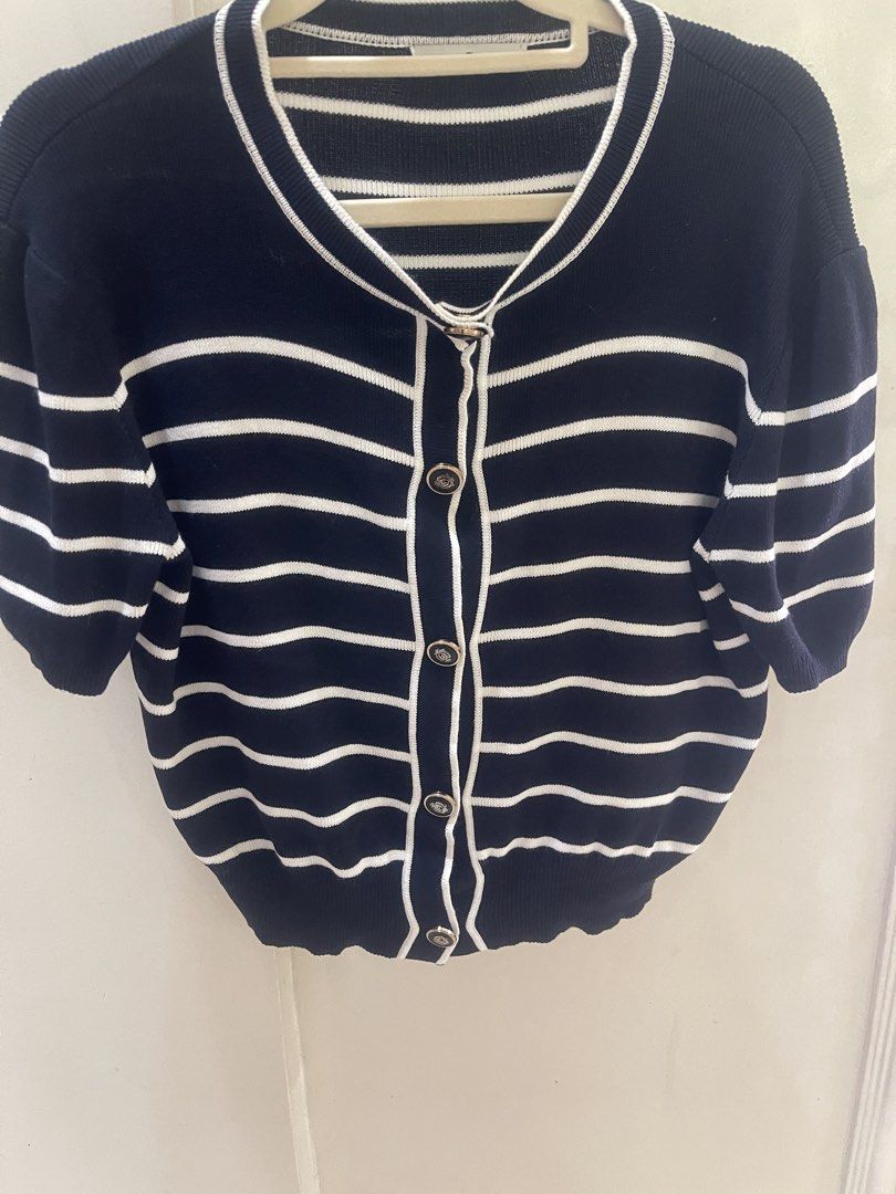 Black Striped Knit Top with Gold Buttons (Category: Shirts) located in Quezon City. Submitted by prelovedluxe_ (Listing ID 1461365428, Image 2). Description: Classic and effortlessly polished black striped knit top featuring elegant contrast piping and decorative gold-tone buttons. The timeless nautical-inspired stripe pattern is complemented by a refined round neckline and button-front detail, creating a sophisticated, feminine look. Made from a