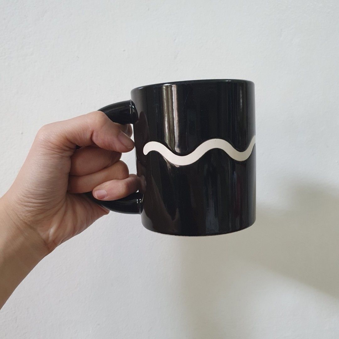 Black wave mug coffee cup (Category: Dinnerware & Cutlery) located in Paranaque City. Submitted by cobien (Listing ID 1461392791, Image 2). Description: - Stylish black coffee mug with a unique wave design. - Brand: Adam & Eve Tachikichi Inc. - Ideal for coffee, tea, or any favorite beverage. - Classic and elegant design..