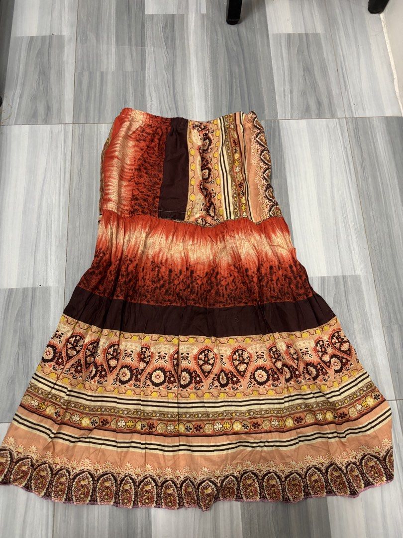 Boho Tiered Maxi Skirt (Category: Skirts) located in Manila. Submitted by lovedbynabix (Listing ID 1461443781, Image 1). Description: - Flowy tiered maxi skirt - Vibrant orange, brown, and cream paisley and striped pattern - Comfortable elasticated waistband - Ideal for casual wear or a bohemian aesthetic - Estimated size M or L (please check measurements).