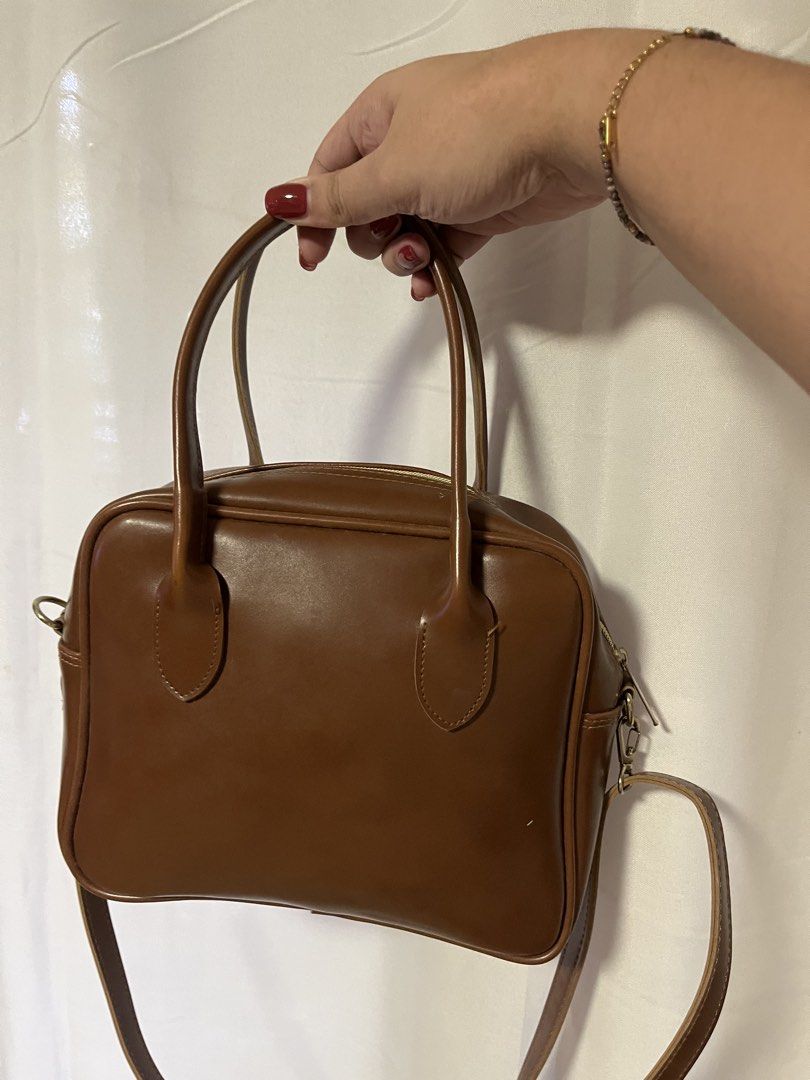 Brown Faux Leather Top Handle Bag with Strap (Category: Shoulder Bags) located in Quezon City. Submitted by rebagged.mnl (Listing ID 1461405742, Image 1). Description: - Classic brown handbag - Faux leather material - Top handles - Detachable shoulder strap - Zipper closure - Ideal for everyday use - Fits your essentials - Simple and functional design.