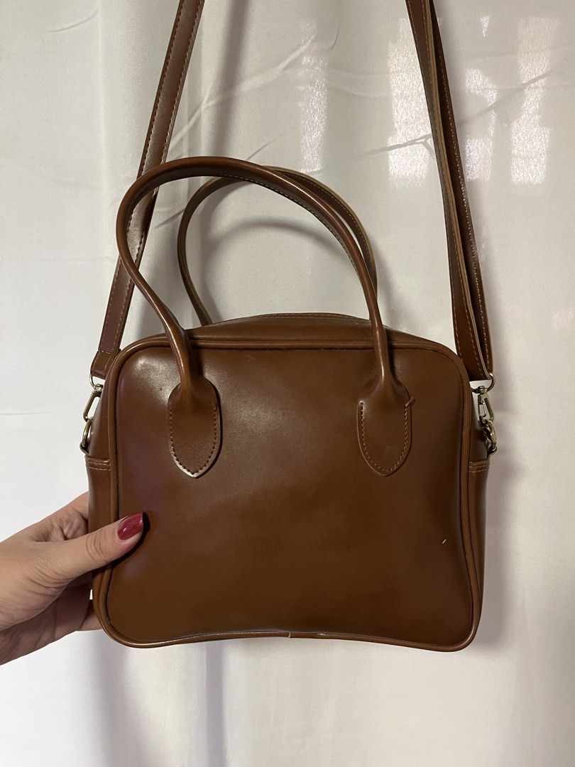 Brown Faux Leather Top Handle Bag with Strap (Category: Shoulder Bags) located in Quezon City. Submitted by rebagged.mnl (Listing ID 1461405742, Image 2). Description: - Classic brown handbag - Faux leather material - Top handles - Detachable shoulder strap - Zipper closure - Ideal for everyday use - Fits your essentials - Simple and functional design.