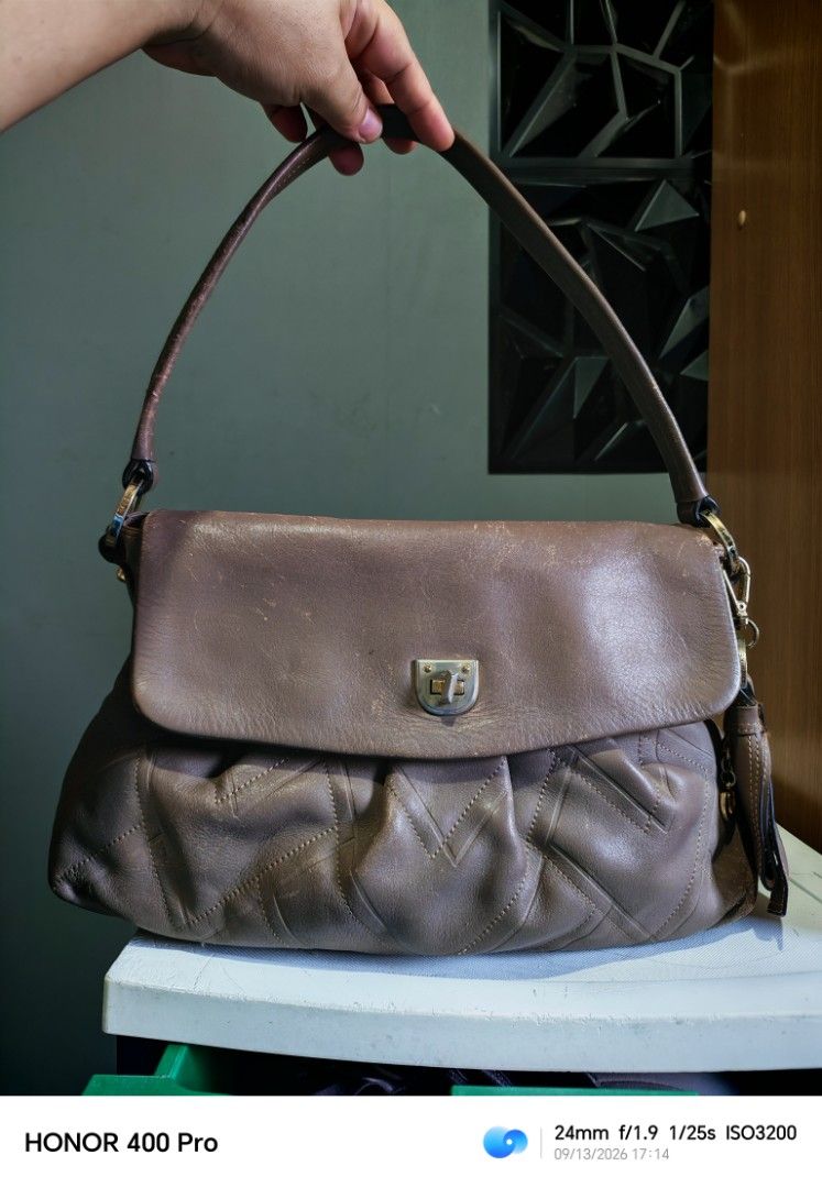 Brown Leather Shoulder Bag (Category: Shoulder Bags) located in Manila. Submitted by cleverwhale_45b7bc (Listing ID 1461432759, Image 2). Description: - Brown leather shoulder bag - Flap closure with metal clasp - Quilted pattern on the front - Top zipper closure - Strap shows some wear - Perfect everyday bag.
