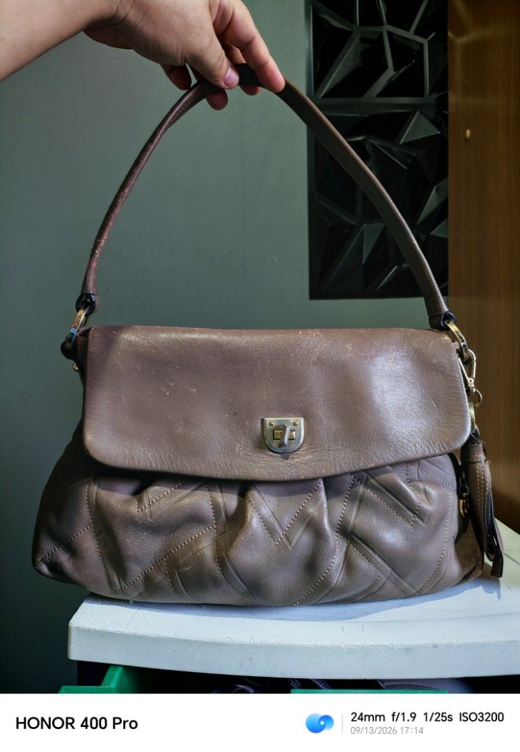 Brown Leather Shoulder Bag (Category: Shoulder Bags) located in Manila. Submitted by cleverwhale_45b7bc (Listing ID 1461432759, Image 1). Description: - Brown leather shoulder bag - Flap closure with metal clasp - Quilted pattern on the front - Top zipper closure - Strap shows some wear - Perfect everyday bag.