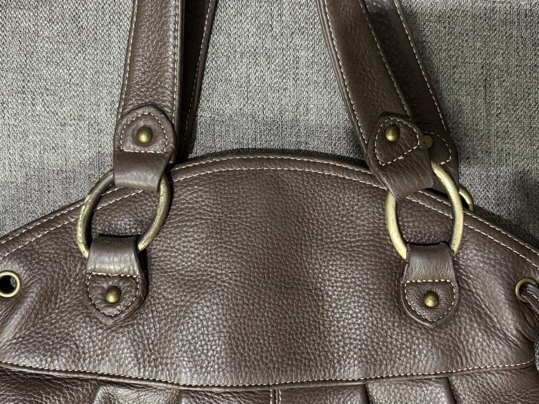 Brown Leather Shoulder Bag with Tassel (Category: Shoulder Bags) located in Manila. Submitted by dns.chu (Listing ID 1461458866, Image 2). Description: - exterior of the bag itself in good condition - slight peeling of gold color on the metal rings of the handle - slight peeling of leather surrounding zipper in the interior compartment - price slightly nego - dm me in interested 📩.