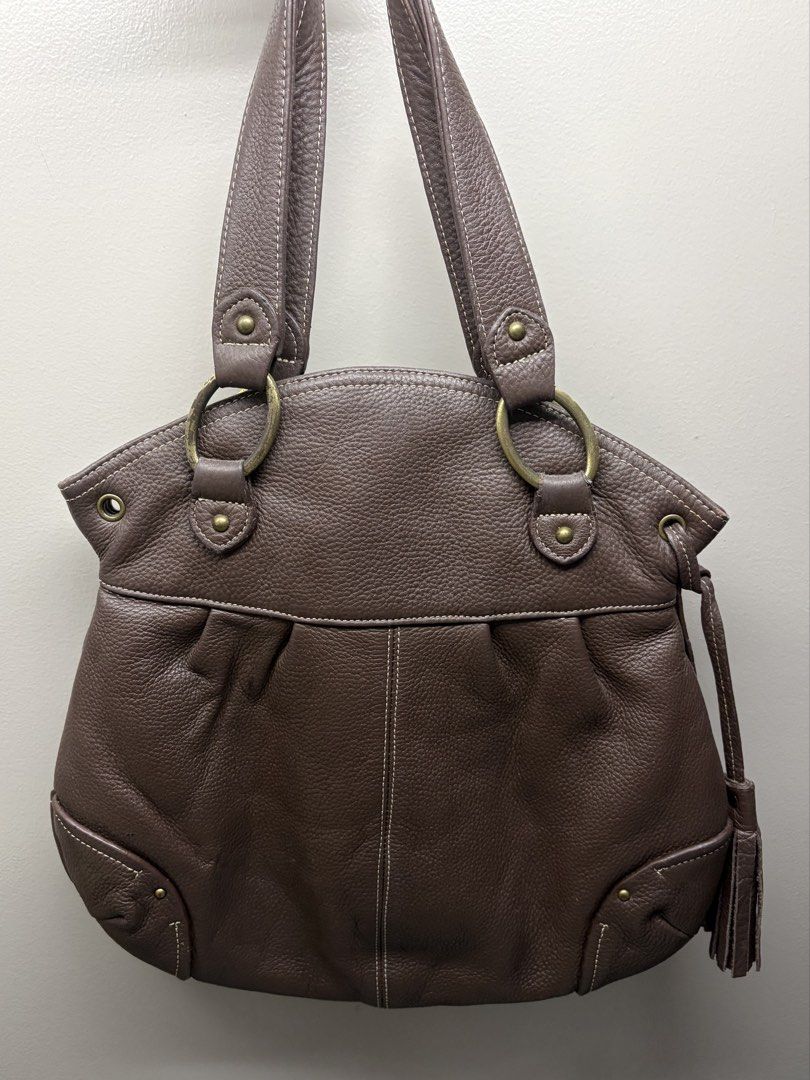 Brown Leather Shoulder Bag with Tassel (Category: Shoulder Bags) located in Manila. Submitted by dns.chu (Listing ID 1461458866, Image 1). Description: - exterior of the bag itself in good condition - slight peeling of gold color on the metal rings of the handle - slight peeling of leather surrounding zipper in the interior compartment - price slightly nego - dm me in interested 📩.