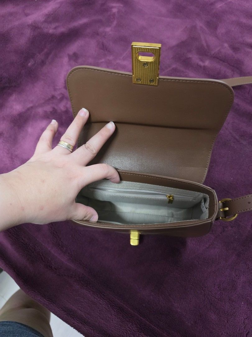 Brown Shoulder Bag with Gold Clasp (Category: Shoulder Bags) located in Manila. Submitted by f3v1nadump (Listing ID 1461377432, Image 3). Description: - Cute brown shoulder bag - Gold clasp closure - Adjustable strap - Interior zippered pocket - Faux leather material - Ideal for everyday use - Fits phone, wallet, and keys.