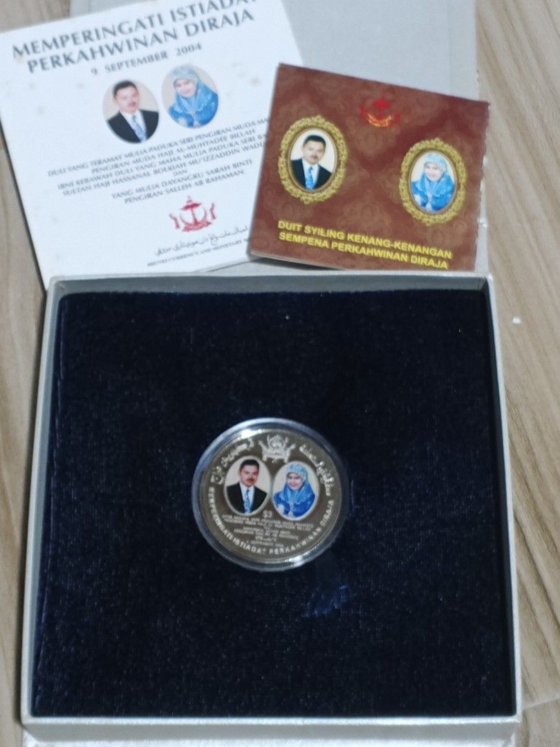 Brunei Royal Wedding Commemorative Coin 2004 (Category: Currency) located in Alfonso. Submitted by caleb_and_mina (Listing ID 1461467366, Image 3). Description: - Commemorative coin from Brunei - Celebrates the Royal Wedding in September 2004 - Features portraits of the royal couple - Comes in a presentation box - Includes accompanying certificates and information booklets - Ideal for coin collectors.