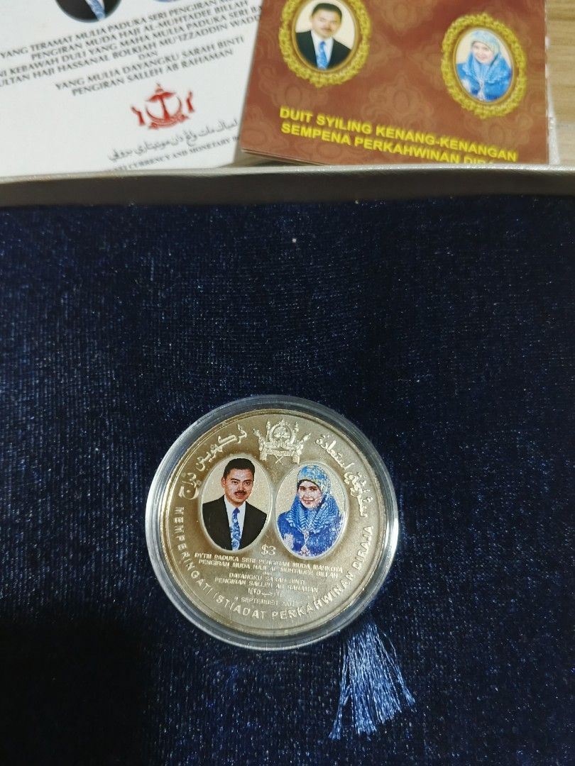 Brunei Royal Wedding Commemorative Coin 2004 (Category: Currency) located in Alfonso. Submitted by caleb_and_mina (Listing ID 1461467366, Image 1). Description: - Commemorative coin from Brunei - Celebrates the Royal Wedding in September 2004 - Features portraits of the royal couple - Comes in a presentation box - Includes accompanying certificates and information booklets - Ideal for coin collectors.