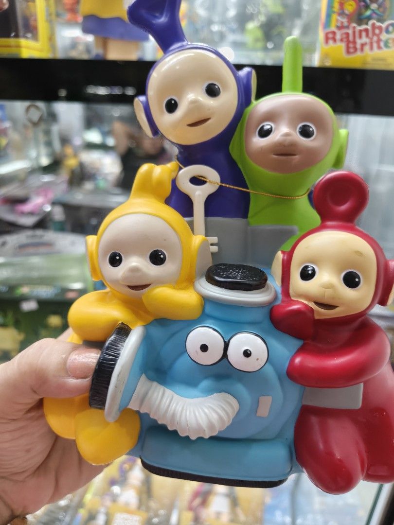 Bullyland Teletubbies Coin Bank 1996 (Category: Vintage Collectibles) located in Manila. Submitted by aterizz (Listing ID 1461444909, Image 1). Description: - Adorable Bullyland Teletubbies coin bank - Features Tinky Winky, Dipsy, Laa-Laa, and Po - Made in 1996 - Handpainted details - Ideal for Teletubbies collectors or as a fun gift for kids - Coin slot located on top - Easy access for retrieving savings from the bottom opening.