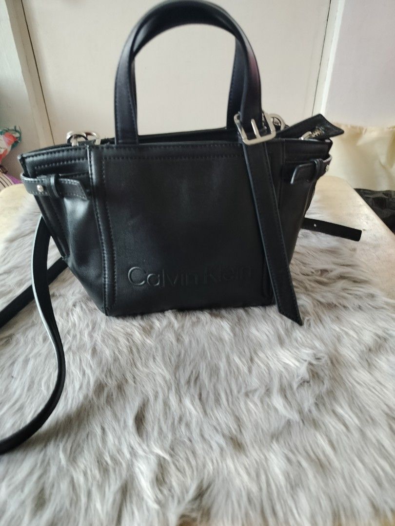 Calvin Klein Black Leather body bag (Category: Cross-body Bags) located in Manila. Submitted by bushe027 (Listing ID 1461398806, Image 3). Description: - Genuine black leather Calvin klein cross body bag - Versatile top handles and detachable shoulder strap - Elegant embossed logo on the front - Timeless, simple design suitable for everyday wear.