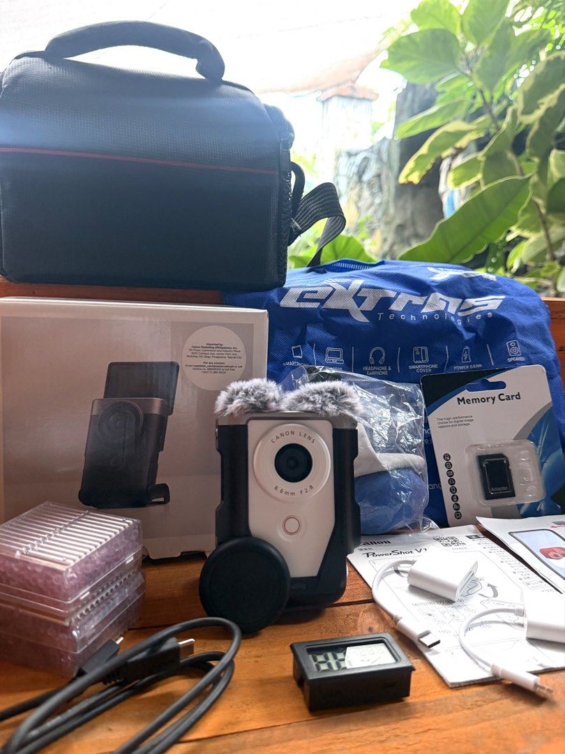 Canon PowerShot V10 Camera Kit with Accessories (Category: Cameras) located in Manila. Submitted by erunmiqlo.26 (Listing ID 1461540721, Image 2). Description: Selling a Canon PowerShot V10 camera. It has a 6.6mm F2.8 lens. Comes with a SmallRig cage and a fuzzy microphone cover. Also includes a camera bag, memory card, USB cables, and charger. Everything you need to start shooting. All items are in the box..