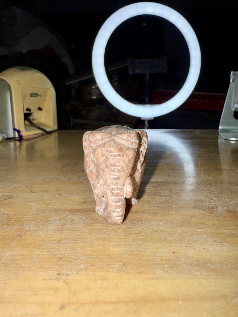 Carved Stone Elephant Figurine (Category: Other Home Decor) located in Pilar. Submitted by faveanyshop (Listing ID 1461354922, Image 2). Description: - Adorable stone elephant carving - Intricate details on trunk and ears - Small hollowed-out section on its back - Perfect for shelf or desk display - Adds charm to any space.