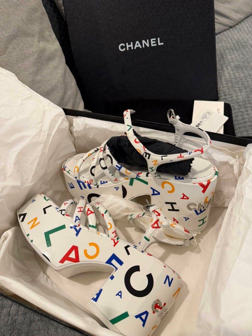 Chanel White Multicolor Logo Platform Sandals (Category: Sneakers & Footwear) located in Makati City. Submitted by dee_online888 (Listing ID 1461412990, Image 2). Description: - Authentic Chanel platform sandals - Eye-catching multicolor logo print on white base - Secure ankle strap closure - Comes with original box and dust bag - Substantial heel height for a dramatic effect - Ideal for making a bold fashion statement.