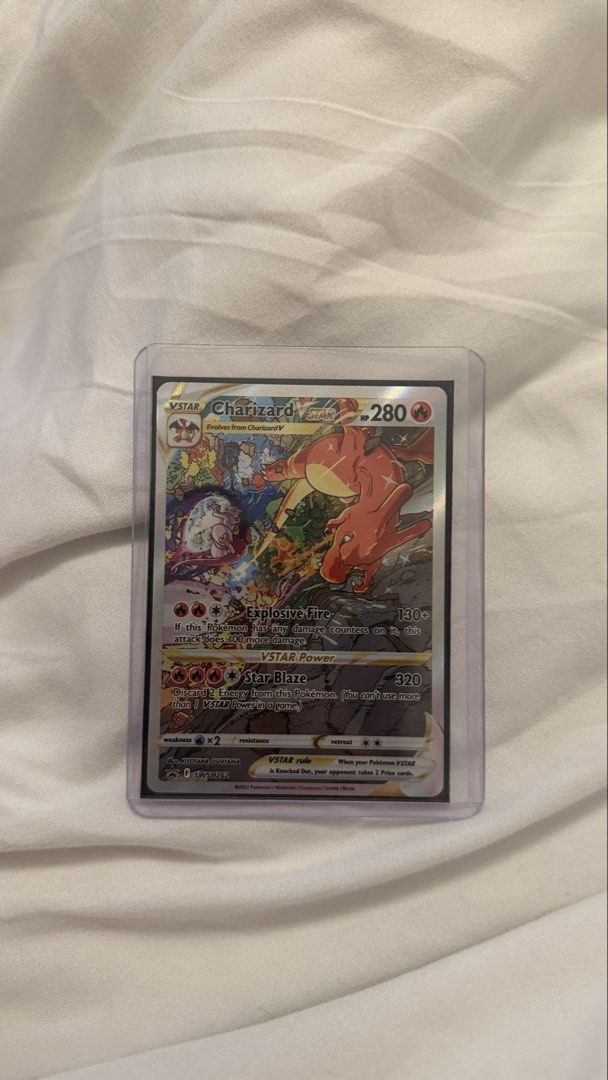 Charizard VSTAR promo Pokemon Card (Category: Raw Singles) located in Manila. Submitted by shopelisse (Listing ID 1461492256, Image 1). Description: - Charizard VSTAR Pokemon Card - HP: 280 - Attack: 'Explosive Fire' (130+ damage) - VSTAR Power: 'Star Blaze' (320 damage) - Comes in a protective sleeve - Ideal for Pokemon TCG collectors.