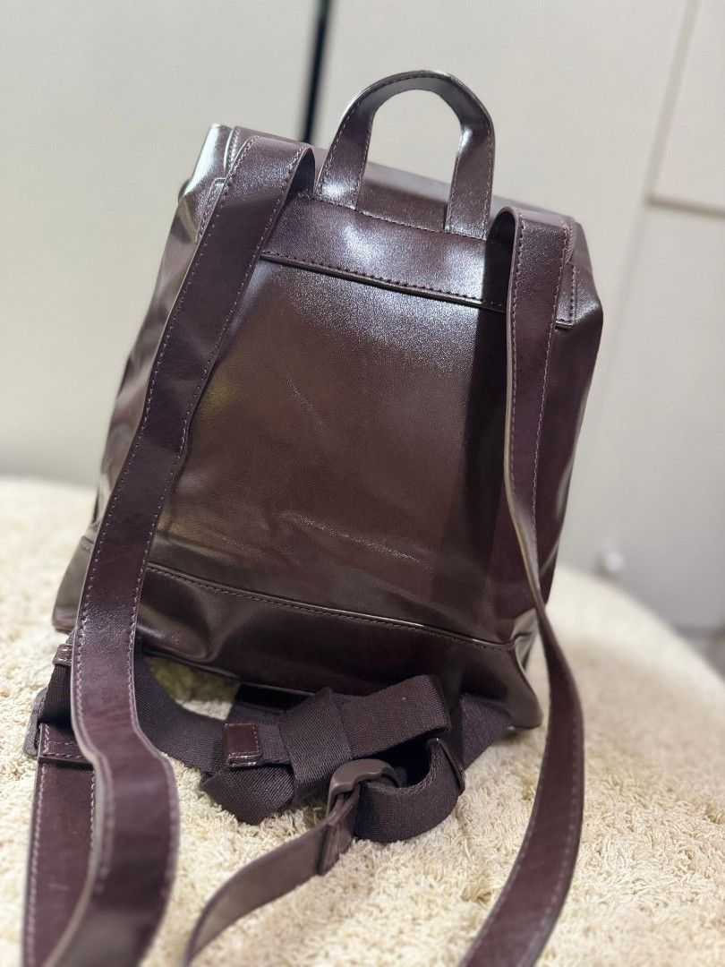 Charles & Keith Brown Leather Drawstring Backpack (Category: Backpacks) located in Manila. Submitted by shy177 (Listing ID 1461390438, Image 2). Description: - Brand: Charles & Keith - Material: Brown Leather - Closure: Drawstring with tassels - Straps: Adjustable for comfort - Style: Minimalist - Features: Spacious interior, ideal for everyday use.