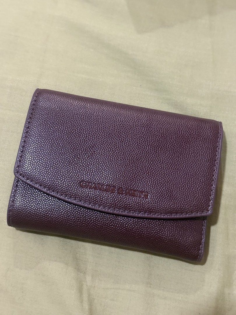 Charles & Keith Burgundy Textured Wallet (Category: Wallets & Card holders) located in Agoo. Submitted by _i6jelly (Listing ID 1461329063, Image 1). Description: - Burgundy textured wallet from Charles & Keith - Secure snap button closure - Interior: Card slots and zippered compartment - Minor wear on magnetic snap closure and zipper pull (functional) - Ideal for organizing your essentials.