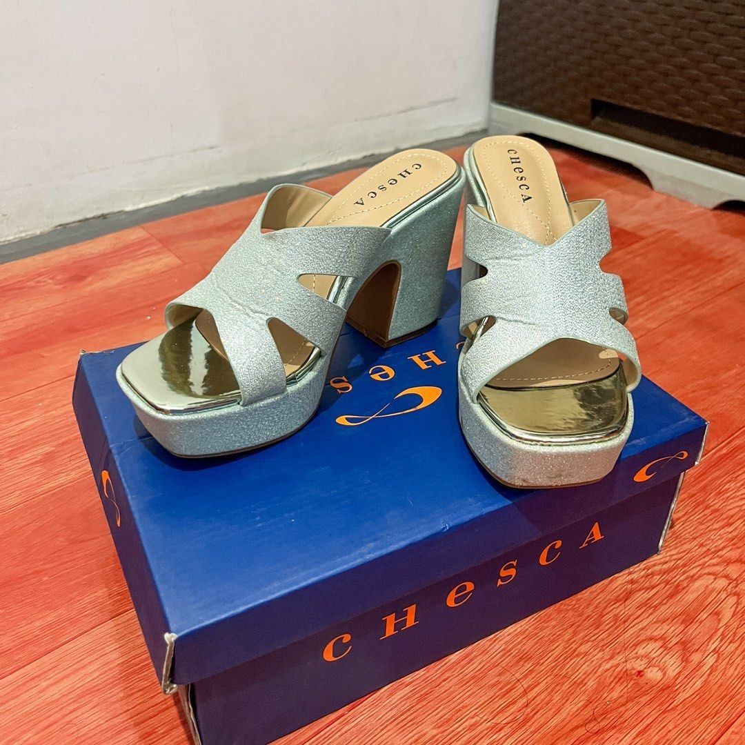 Chesca Silver Glitter Platform Heels (Category: Heels) located in Naic. Submitted by cymelpochos (Listing ID 1461507714, Image 1). Description: - Sparkly silver platform heels - Brand: Chesca - Style: Open-toe mule with criss-cross straps - Heel: Chunky block heel for comfort and height - Includes: Original Chesca box - Perfect for: Parties or dressing up any outfit - Original Price: P1999 - Ready for new owner.