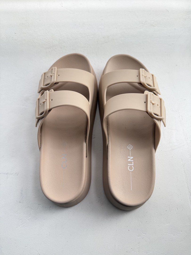 CLN Beige Double Strap Platform Slides (Category: Flats & Sandals) located in Pasig City. Submitted by yoroshikuonegaishimasu (Listing ID 1461446599, Image 2). Description: Beige CLN slides Adjustable double straps Size: 41 EUR / 8 UK / 10 USA Issue: Need idikit yung mga straps, natanggal na yung dikit Payment via GCash or Paymaya No Meet-up/COD/COP No return, exchange or refund Delivery: Grab or Lalamove J&T (during weekend only) Location: Pasig