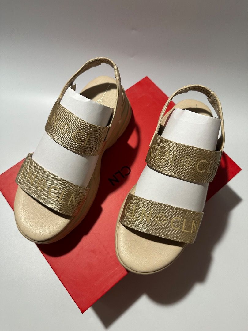 CLN Beige Platform Sandals with Gold Logo Straps (Category: Sandals) located in Calamba. Submitted by daisy214 (Listing ID 1461541032, Image 3). Description: - Brand: CLN - Color: Beige - Style: Platform Sandals - Features: Gold logo straps across the front, chunky sole for comfort and style - Condition: Comes with original CLN box - Occasion: Great for casual wear.