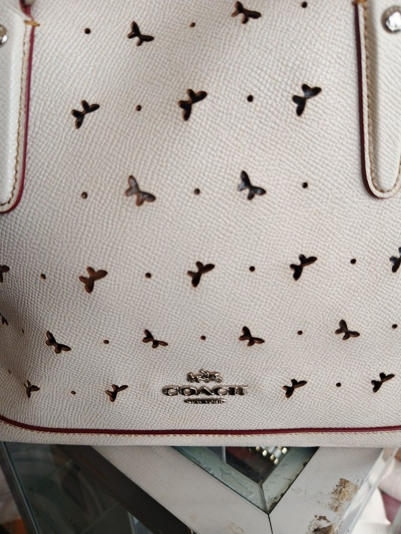 Coach Bag (Category: Luxury Bags & Wallets) located in Tayabas. Submitted by sickfinds (Listing ID 1461484554, Image 3). Description: This is a white Coach Sierra Satchel featuring a perforated butterfly pattern. In Excellent Condition.