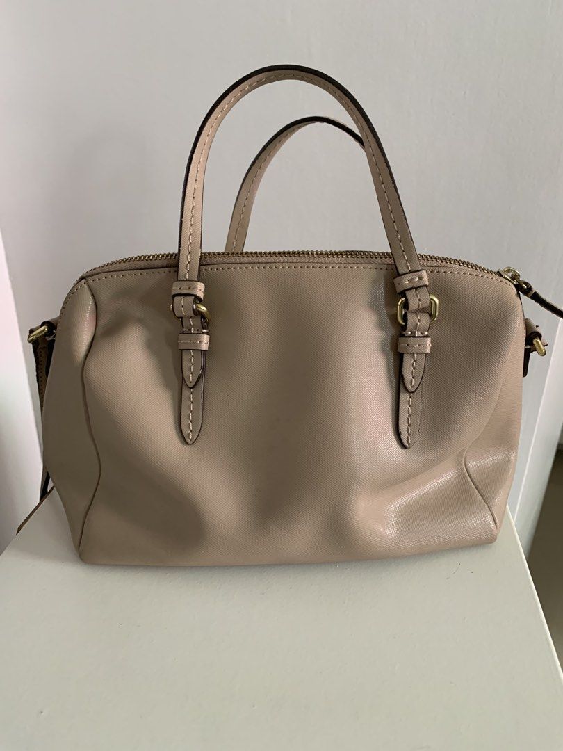 Coach Beige Leather Satchel Bag with Strap (Category: Luxury Bags & Wallets) located in Quezon City. Submitted by artsymabel (Listing ID 1461339071, Image 2). Description: - Beige Coach satchel bag - Genuine leather material - Features top handles - Includes a detachable crossbody strap - Secure zipper closure - Interior: 1 zippered pocket, 1 slip pocket - Noted: Minor signs of wear on strap and zipper area - Noted: A few small marks inside - Per
