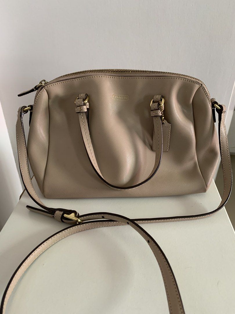 Coach Beige Leather Satchel Bag with Strap (Category: Luxury Bags & Wallets) located in Quezon City. Submitted by artsymabel (Listing ID 1461339071, Image 1). Description: - Beige Coach satchel bag - Genuine leather material - Features top handles - Includes a detachable crossbody strap - Secure zipper closure - Interior: 1 zippered pocket, 1 slip pocket - Noted: Minor signs of wear on strap and zipper area - Noted: A few small marks inside - Per