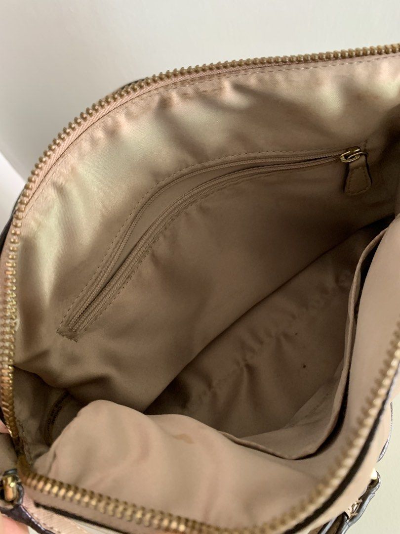 Coach Beige Leather Satchel Bag with Strap (Category: Luxury Bags & Wallets) located in Quezon City. Submitted by artsymabel (Listing ID 1461339071, Image 3). Description: - Beige Coach satchel bag - Genuine leather material - Features top handles - Includes a detachable crossbody strap - Secure zipper closure - Interior: 1 zippered pocket, 1 slip pocket - Noted: Minor signs of wear on strap and zipper area - Noted: A few small marks inside - Per