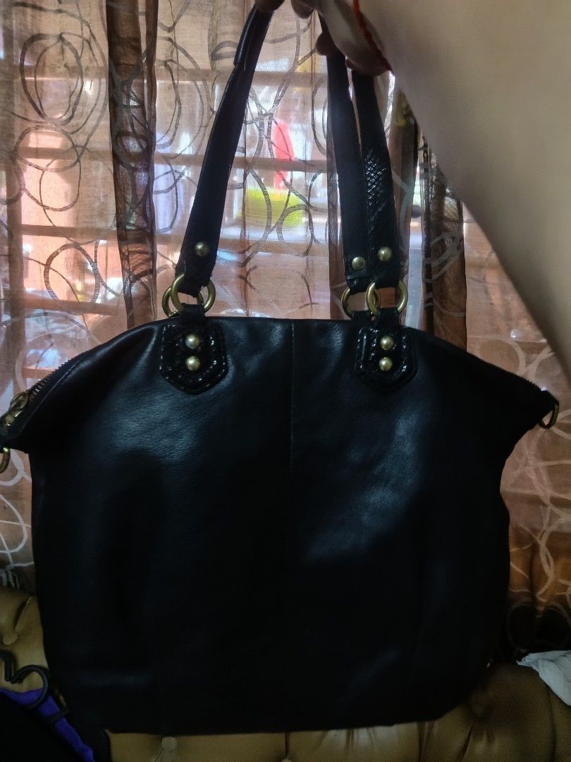 Coach Black Leather Handbag (Category: Luxury Bags & Wallets) located in Quezon City. Submitted by bshoppe_ (Listing ID 1461345770, Image 2). Description: - Genuine black leather Coach handbag - Textured detail on the front flap - Secure zipper closure - Multiple interior compartments and pockets for organization - Leather straps with textured detail - Elegant gold hardware - Ideal for everyday use.
