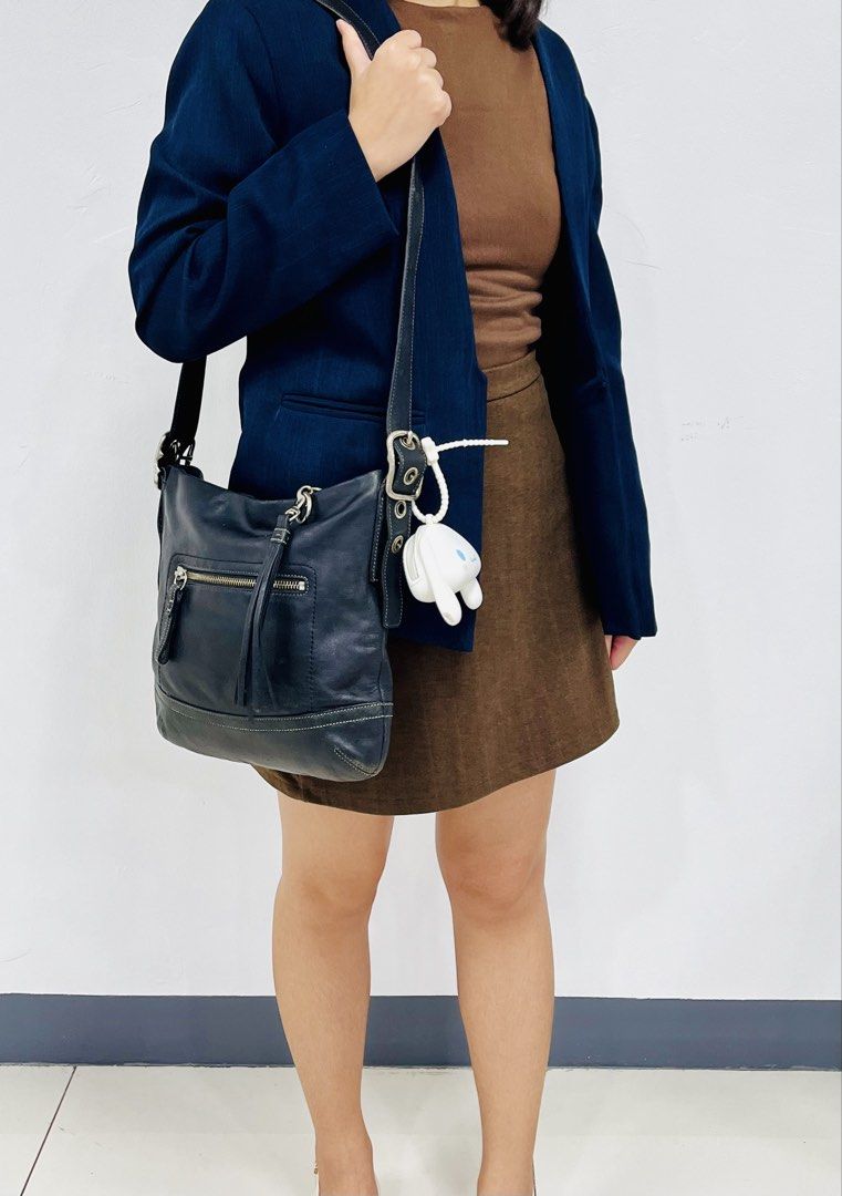Coach Black Leather Hobo Shoulder Bag (Category: Luxury Bags & Wallets) located in Pasig City. Submitted by zen_it_all (Listing ID 1461368883, Image 2). Description: - Authentic leather Coach hobo bag - Elegant white stitching details - Convenient front zip pocket - Secure main zip closure - Adjustable shoulder strap for comfort - charm not included - Ideal everyday bag. / can be unisex - flaws: upper lip portion / zipper puller (but overall cond