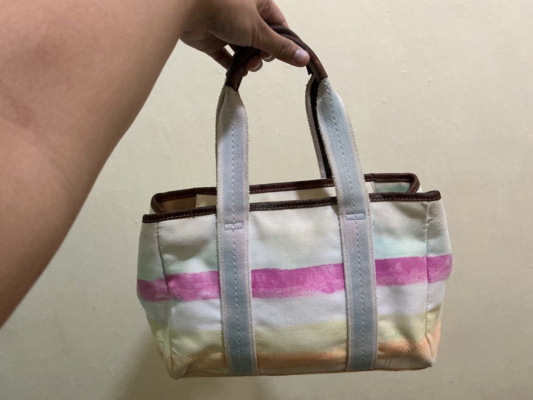 Coach Hampton Canvas Striped Tote Bag (Category: Luxury Bags & Wallets) located in Quezon. Submitted by whimsycart (Listing ID 1461455726, Image 2). Description: - Cute Coach tote bag - Colorful stripe design - Durable canvas material with leather trim and handles - Ideal for everyday use - Features an interior zipper pocket - Shows some signs of wear, but plenty of life left - Perfect size for carrying essentials medj faded color lang huhu + may